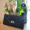 Black Leather Purse with Champagne Flutes, Bottle of Champagne and a Plant