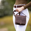 Dark Brown Temara Square Small Saddle Bag Held by Person Wearing White Jeans
