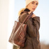 Dark Brown Tote Bag Held by Woman Wearing a Brown Coat